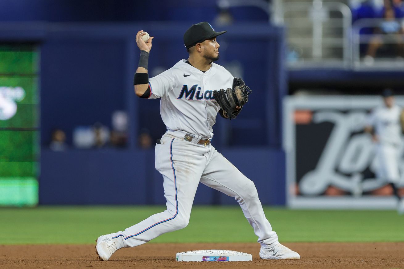 Luis Arraez turns a double play against the Braves.