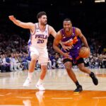 Mar 25, 2023; Phoenix, Arizona, USA; Phoenix Suns forward T.J. Warren (21) dribbles past Philadelphia 76ers forward Georges Niang (20) during the game at Footprint Center. Mandatory Credit: Chris Coduto-USA TODAY Sports