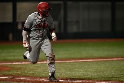 Jordan Procyshen runs between first base and second base.
