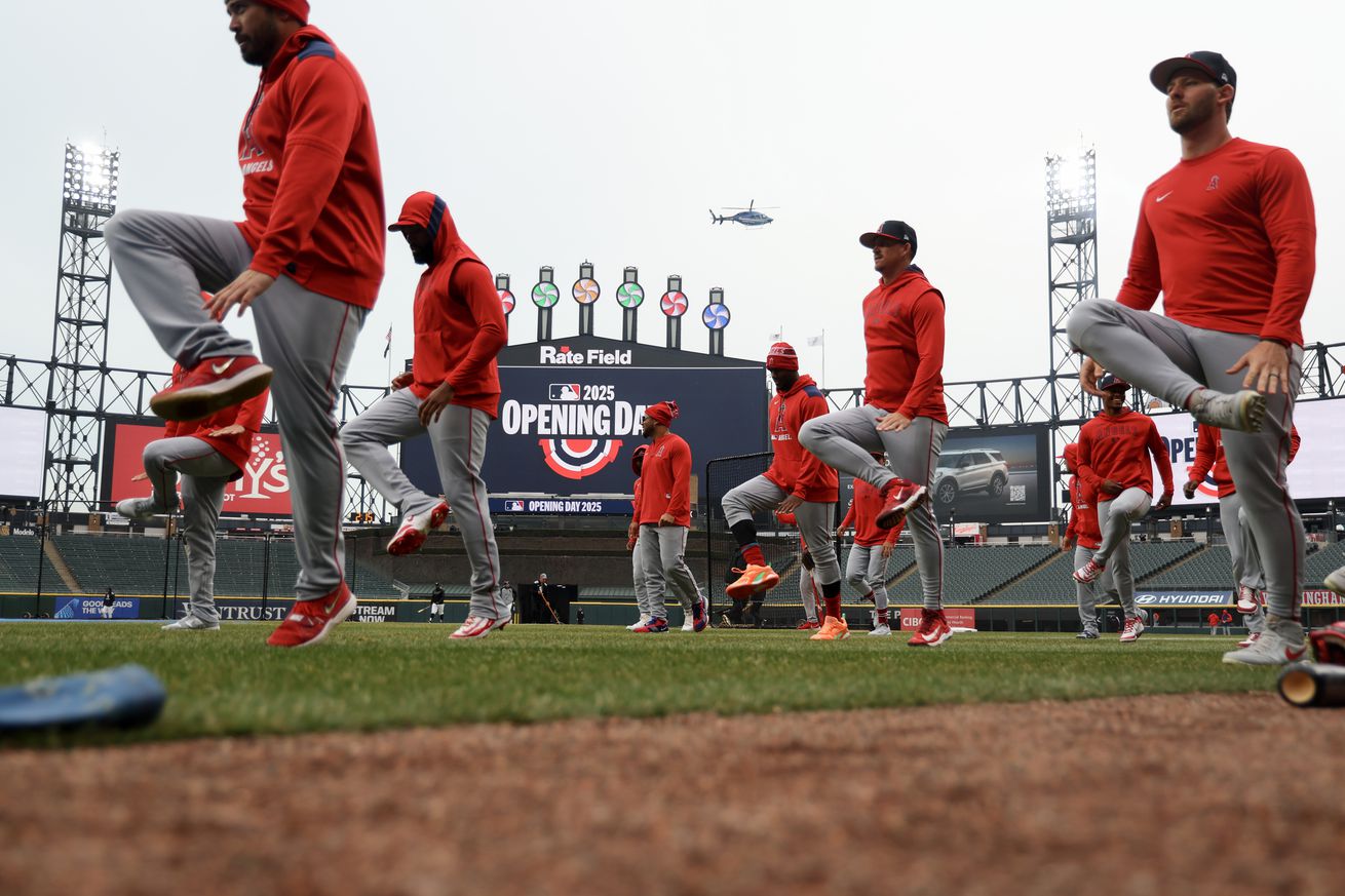 Angels players warming up in front of a jumbotron that says MLB Opening Day