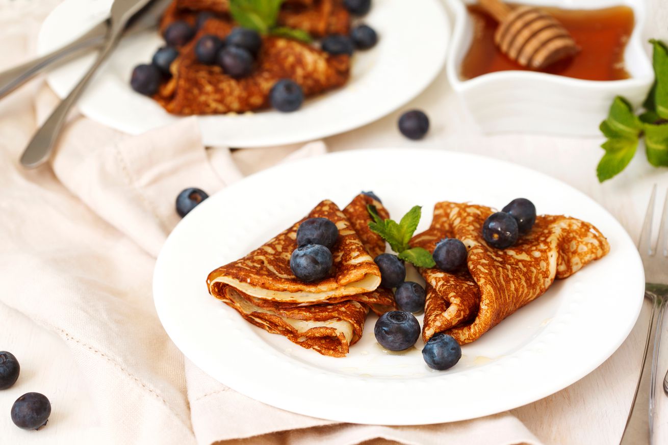 Homemade crepes with fresh blueberries and honey.