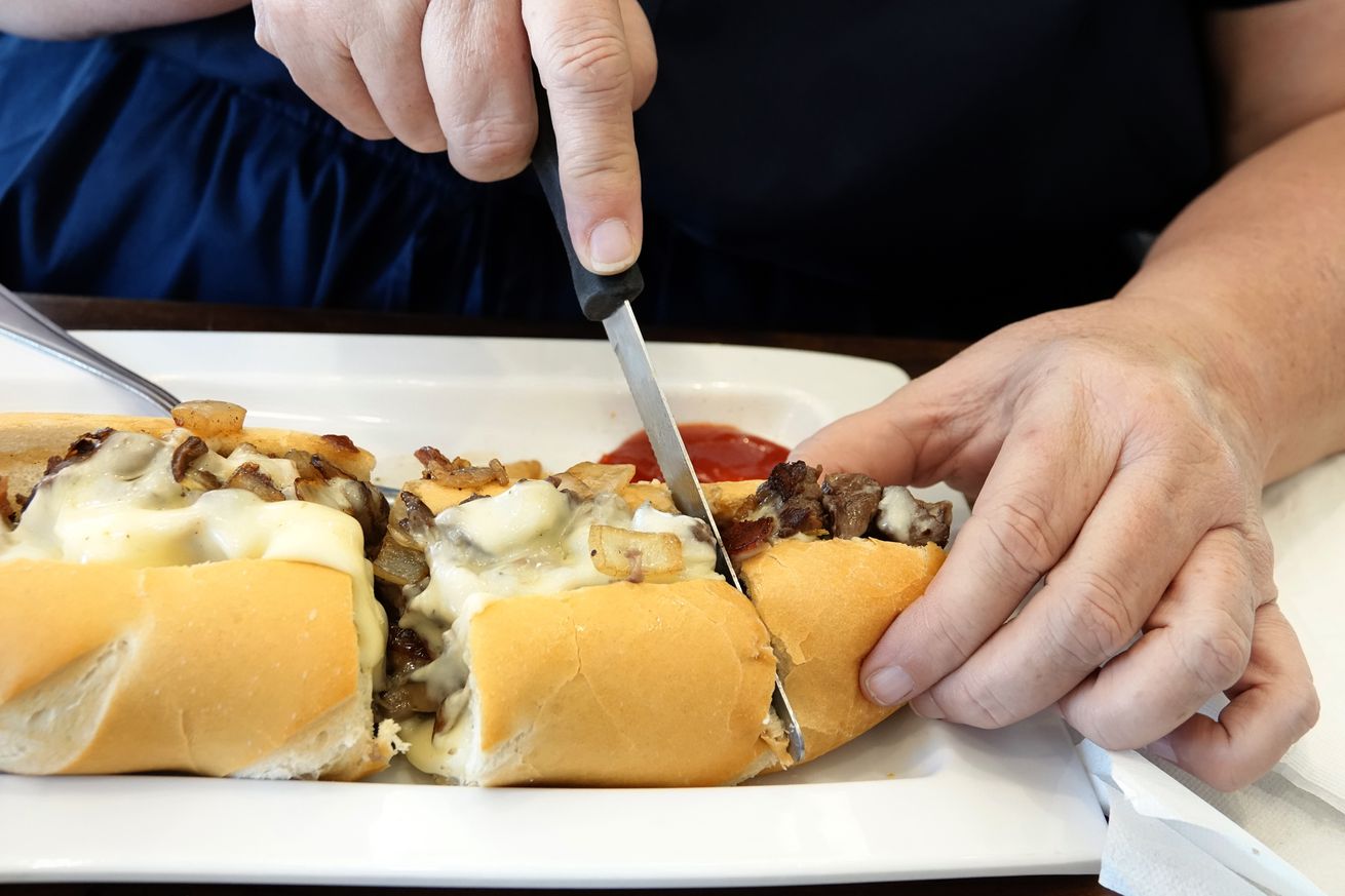 Miami Beach, Manolo, Argentinean restaurant, cutting cheese steak sandwich