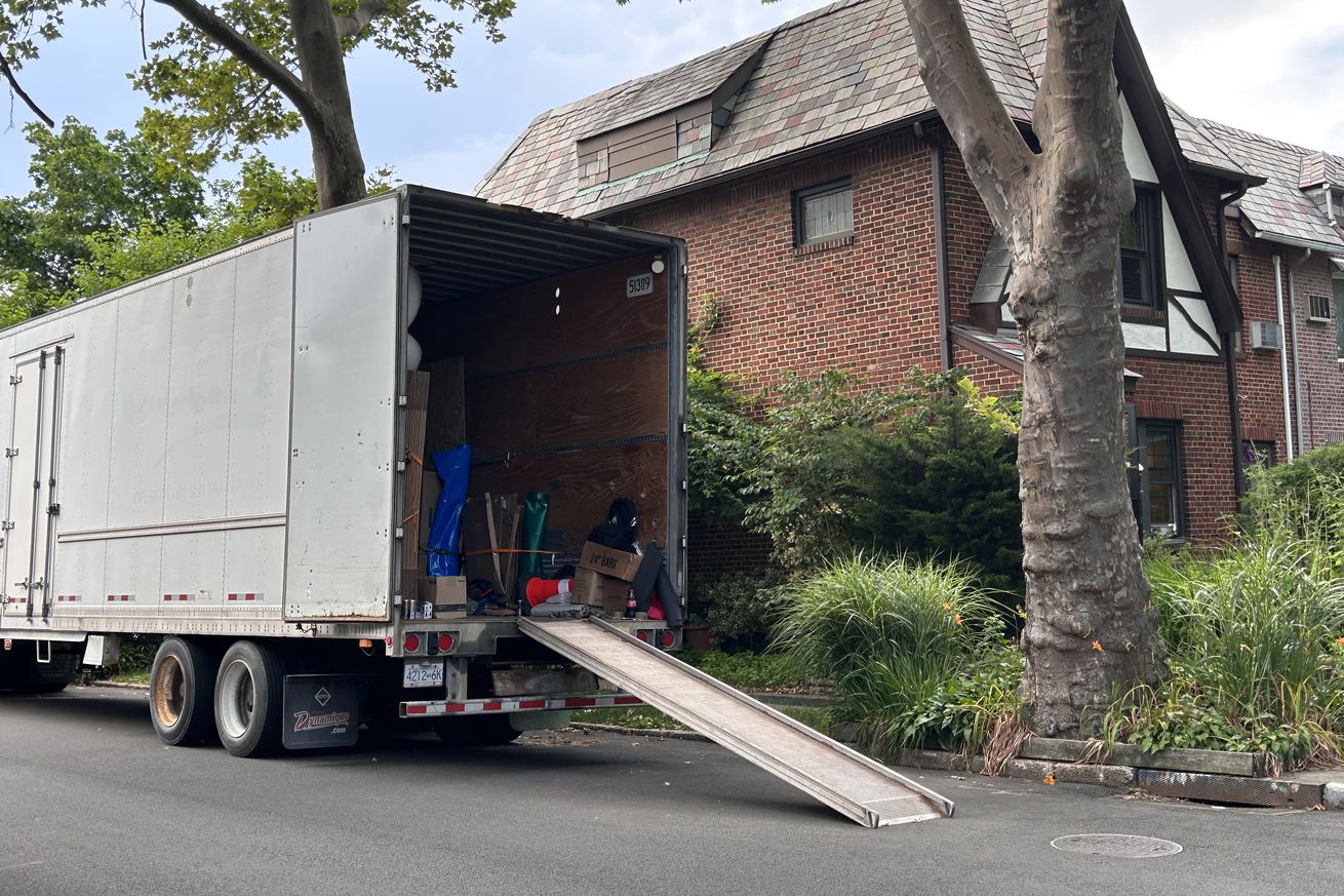Moving truck and loading ramp outside home, Queens, New York