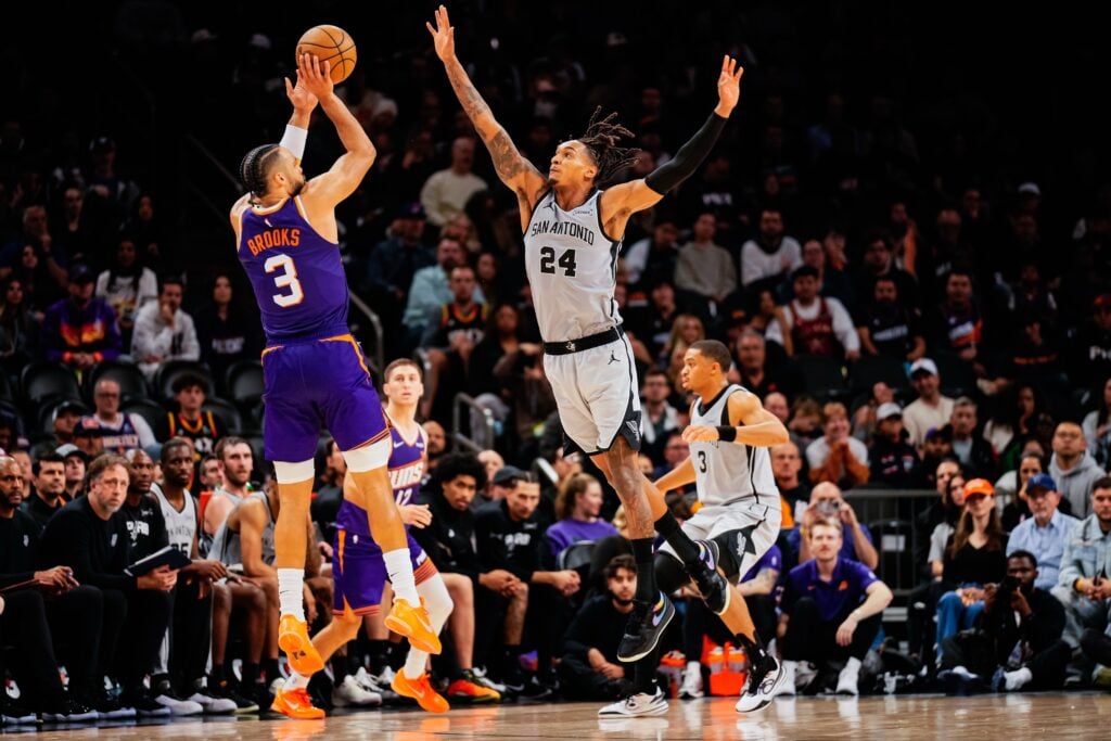Phoenix Suns forward Dillon Brooks (3) takes a shot against San Antonio Spurs guard Devin Vassell (24) in the second half of the game at Mortgage Match Up Center.
