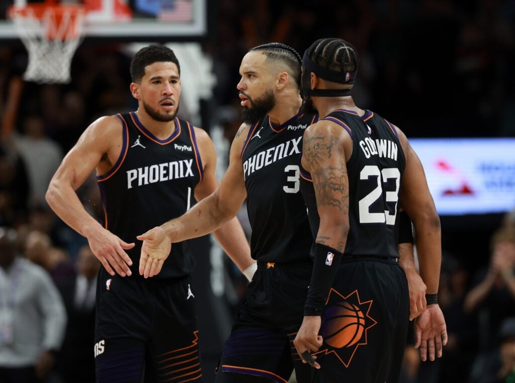 Phoenix Suns forward Dillon Brooks (3) celebrates with teammates Devin Booker (1) and Jordan Goodwin (23) against the Oklahoma City Thunder in the second half at Mortgage Matchup Center.