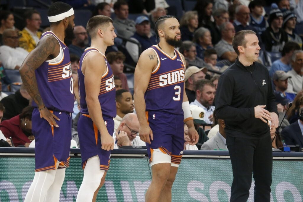 Jan 7, 2026; Memphis, Tennessee, USA; Phoenix Suns forward Royce O'Neale (00), guard Grayson Allen (8), forward Dillon Brooks (3) and head coach Jordan Ott look onduring the second quarter against the Memphis Grizzlies at FedExForum. Mandatory Credit: Petre Thomas-Imagn Images